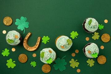 St. Patrick's Day vanilla and chocolate cupcakes with green frosting and  shiny clover decorations...