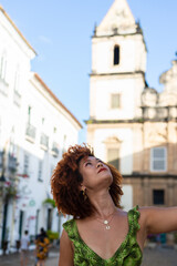 Fototapeta premium Beautiful red-haired woman looking up. Happy person traveling.