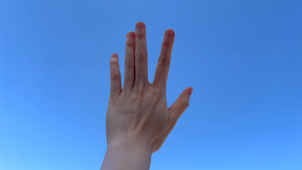 hands hand reaching in clear clean blue sky motion stretching arm symbol success, hope god love happy victory peace spring beautiful sunny day looking at bright light 4k hd