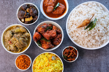Kerala special food sadhya in banana leaf plate with Chicken fry Duck roast Beef fry Fish curry Cabbage thoran. Festival food for Christmas Easter celebration Kerala India Sri Lanka