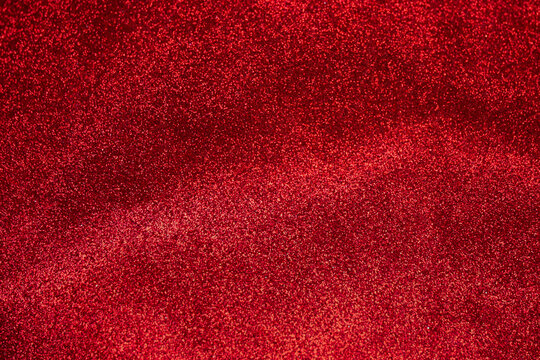Red glitter bokeh abstract background. Copy space for your design. Selective focus.