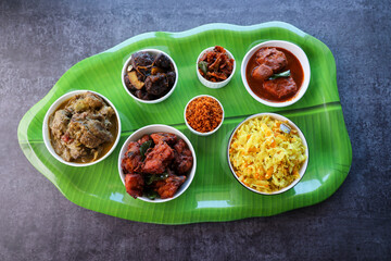 Kerala special food sadhya in banana leaf plate with Chicken fry Duck roast Beef fry Fish curry Cabbage thoran. Festival food for Christmas Easter celebration Kerala India Sri Lanka