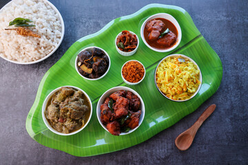 Kerala special food sadhya in banana leaf plate with Chicken fry Duck roast Beef fry Fish curry Cabbage thoran. Festival food for Christmas Easter celebration Kerala India Sri Lanka