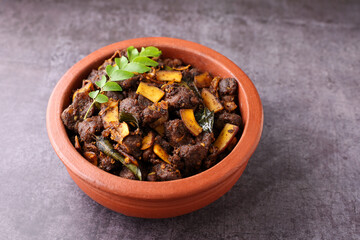 Spicy red beef fry curry and brown rice South Indian dish Kerala, India. side of Ghee rice, Appam, Parotta, Puttu. traditional Christian Muslim feast dish. Buffalo roast, meat pepper fry with coconut.