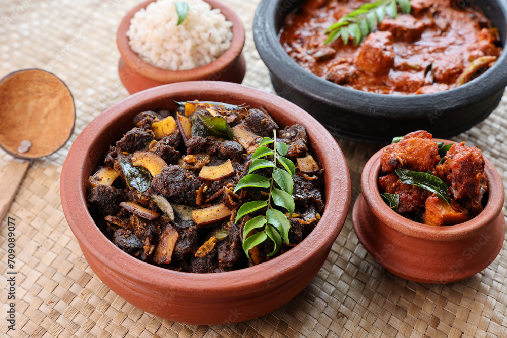 Wall mural spicy red beef fry curry and brown rice south indian dish kerala, india. side of ghee rice, appam, p