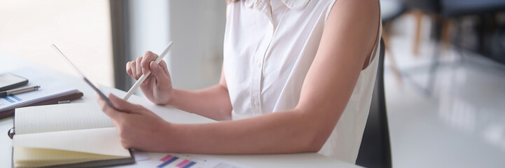 Asian businesswomen reading marketing business report to checking financial chart data on digital...