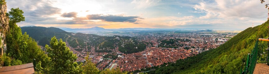 Brasov, Transylvania. Romania. Aerial panoramic view of the old town and Council Square, Aerial twilight cityscape of Brasov city
