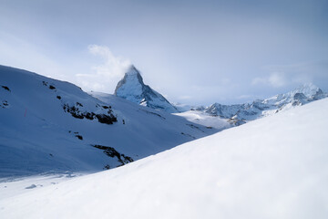 Fototapeta na wymiar Matterhorn, Switzerland. Winter mountain landscape. A place for skiing. Zermatt ski resort. High rocks and snow. View of the mountain in Switzerland.