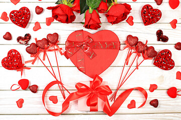 Celebration of Valentine's Day or Women's Day, Mother's Day, banner. Greeting card, roses, hearts and gift boxes on a wooden background, happy holiday, birthday greetings,