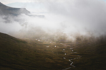 misty morning in the mountains with small stream