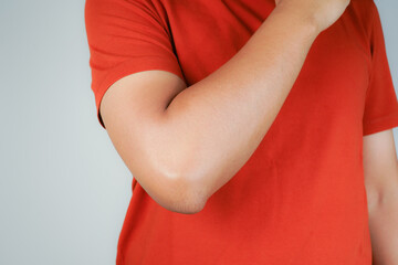 Health concept, person with elbow pain, man holding hand on elbow with pain, bone arthritis