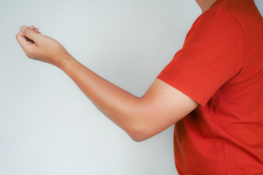 Health concept, person with elbow pain, man holding hand on elbow with pain, bone arthritis