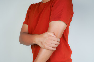 Health concept, person with elbow pain, man holding hand on elbow with pain, bone arthritis