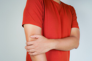 Health concept, person with elbow pain, man holding hand on elbow with pain, bone arthritis