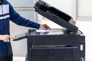 Businessman press button on panel of printer photocopier  network , Working on photocopies in the...