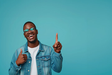 Naklejka premium Banner Cheerful african man wearing glasses jean jacket having white snow smile pointing fingers aside at copy space for your text advertisement, advertise teeth whitening or eyewear store good offer 