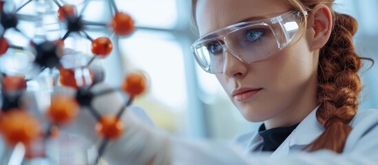Female scientist with molecule model, close-up. Science research, study of chemical and physical findings.
