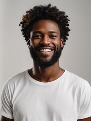 Fototapeta premium a closeup photo portrait of a handsome black afro american man smiling with clean teeth and a white t-shirt. for a dental ad. guy with beard with strong jawline with white background 4k