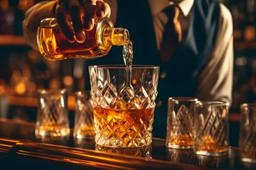 Keuken spatwand met foto a person pouring alcohol into a glass © John
