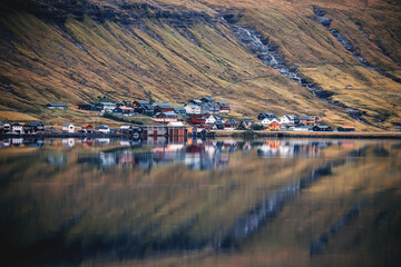 view of the city by the nordic fjord with mirror reflections in the water