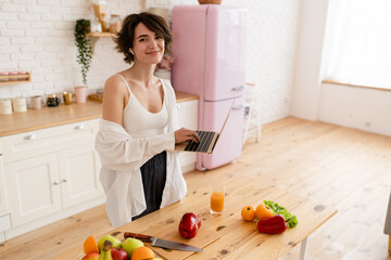 young pretty woman cooking at home, morning kitchen, healthy food