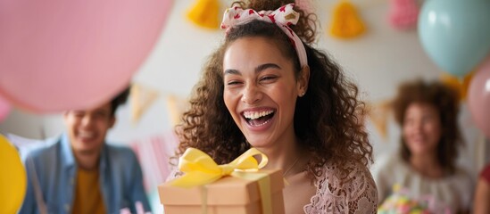 Expectant woman happily celebrates her pregnancy surrounded by loved ones at a baby shower, expressing gratitude for their support and being excited about the gift box symbolizing motherhood. - obrazy, fototapety, plakaty