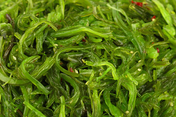 Close up background of green wakame seaweed salad