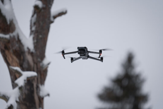 Estonia, Tallinn, January 13, 2024. Drone dji mavic 3 classic in the air in the forest in winter.