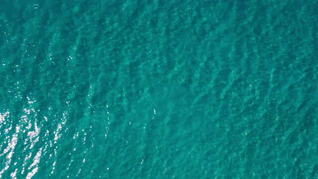 Background of crystal sea surface with deep turquoise water, Aerial top down view