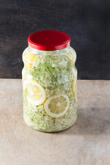 Elder flowers drink juice glass. White flower and lemon. Harvesting buds for making syrup and drink...