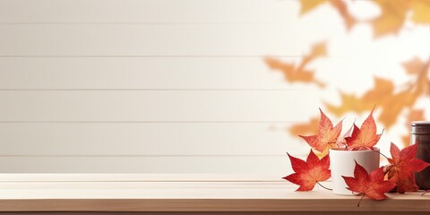 Minimal autumn concept with creative autumn composition featuring a screen banner, displayed on an empty wooden kitchen table with maple leaves.