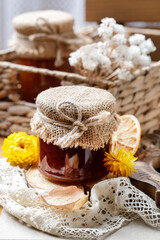 Jar of honey on wooden table.