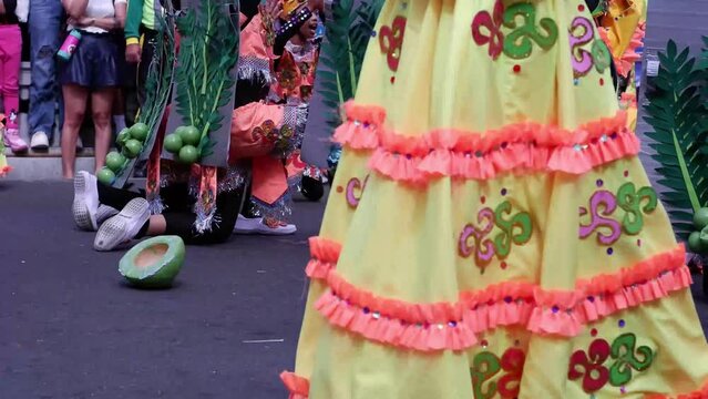 During the annual celebration of the coconut festival, street dancers in various local and native costumes perform in a frenzy along the street to pay homage to a Patron Saint.