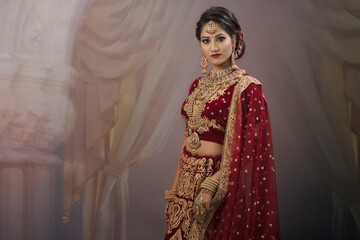 Young Indian female in ethnic Indian wear celebrating festival of Diwali. Indian female with bridal make-up and bridal wear