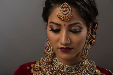 Young Indian female in ethnic Indian wear celebrating festival of Diwali. Indian female with bridal...