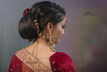 Young Indian female in ethnic Indian wear celebrating festival of Diwali. Indian female with bridal...