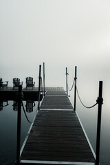 Dock on a lake in heavy fog.