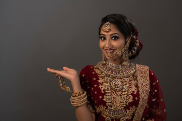 Young Indian female in ethnic Indian wear celebrating festival of Diwali. Indian female with bridal...