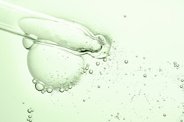 The texture of a cosmetic serum with a pipette closeup. Copy space