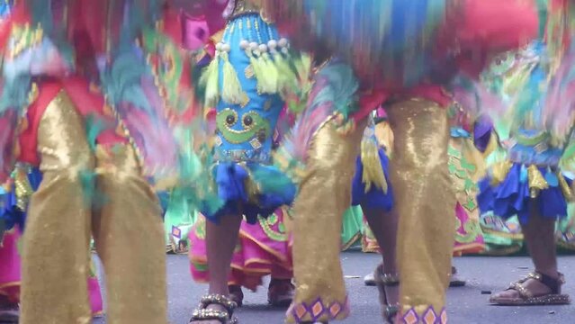 During the annual celebration of the coconut festival, street dancers in various local and native costumes perform in a frenzy along the street to pay homage to a Patron Saint.