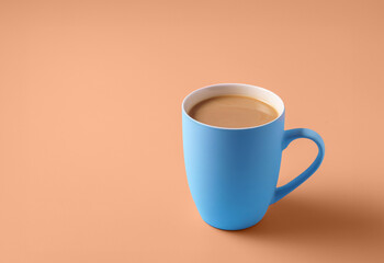 a cup of coffee on Peach Fuzz color background.