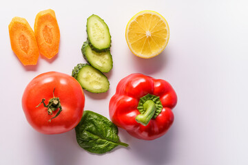 Flat lay of different vegetables on white background, copy space. Food concept.