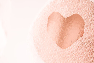 The Heart in the Air bubble wrap package. Valentine's Day. Peach color. Family love. Copy space.