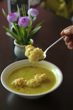 A bowl of Celimpungan.  This food like Laksan but with large sized tekwan balls instead of sliced pempek. A coconut milk gravy, the thick sauce is simmered with turmeric, pepper, bay leaves.