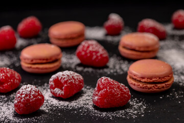 macaroons of different colors on a black background