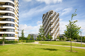 Residential area in the city, modern sustainable high-rise apartment buildings in a green...