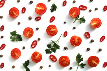 Texture of chopped tomatoes, hot peppers and parsley on a white background.	