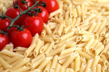  Background of pasta and cherry tomatoes on a branch.	