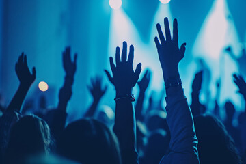 People raising their hands at a concert