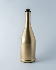 Golden champagne bottle on white background. Minimal celebration concept.